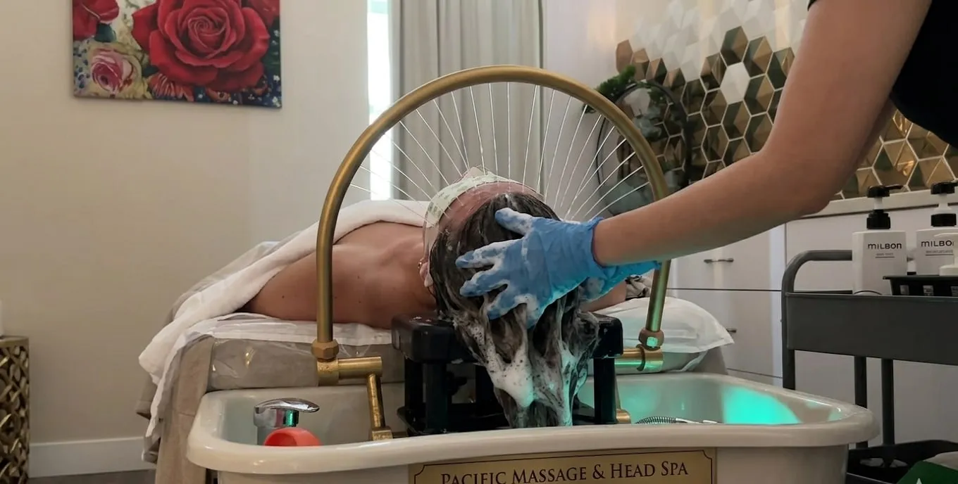 Therapist working through a guest's scalp at the hydrotherapy basin during a head spa session at Pacific Massage & Head Spa in Redmond, WA